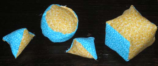A small set of Quilt Hopper pieces: 2 cones, a block, and a puck